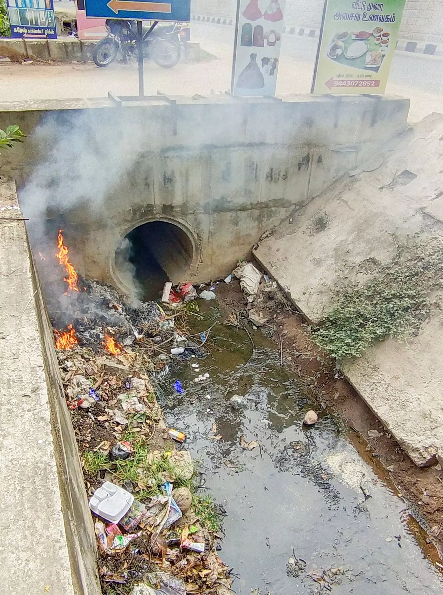 கால்வாயில் குப்பையை கொட்டி தீ வைப்பு