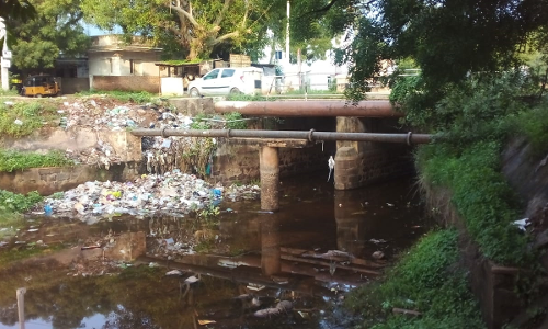 கால்வாயில் கொட்டப்படும் குப்பைகள்