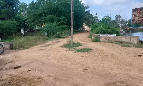 சாலையின் நடுவே உள்ள மின்கம்பம் சாலையின் நடுவே உள்ள மின்கம்பம்